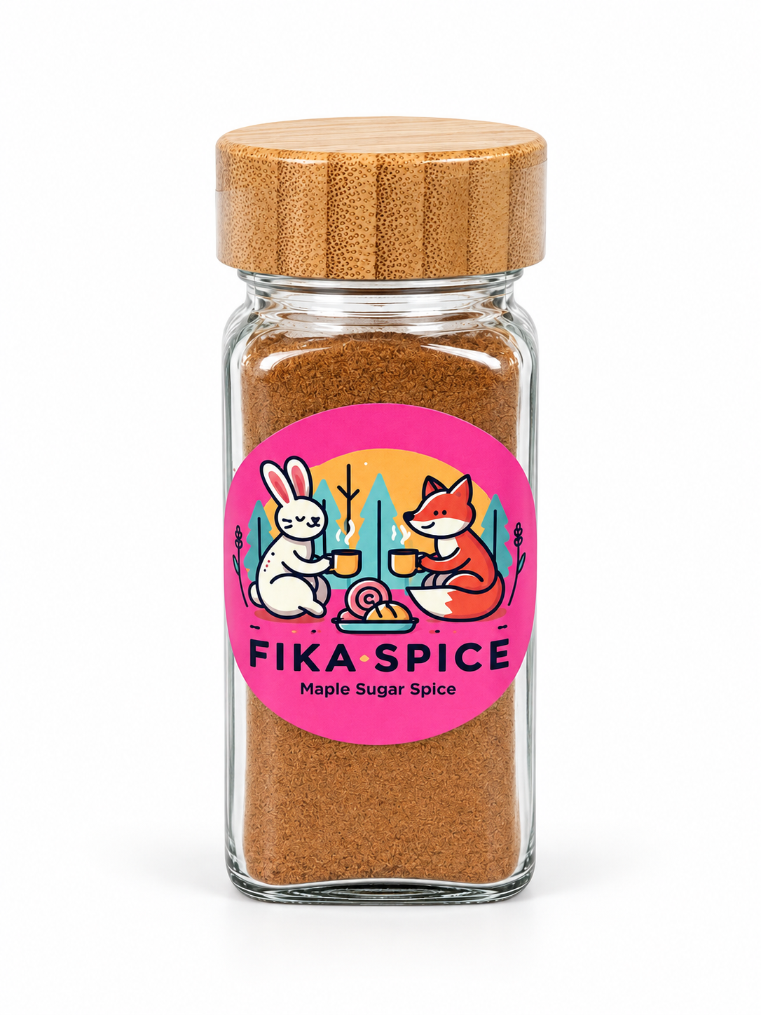 A clear glass spice jar filled with brown Fika Spice, topped with a light wood lid and featuring a bright pink circular label with cartoon rabbit and fox illustrations and the text 'FIKA SPICE' and 'Maple Sugar Spice'.